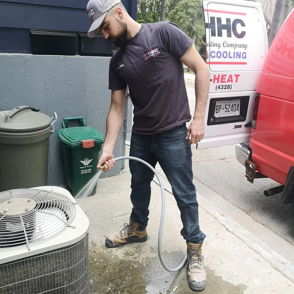 Technician servicing an air conditioning unit